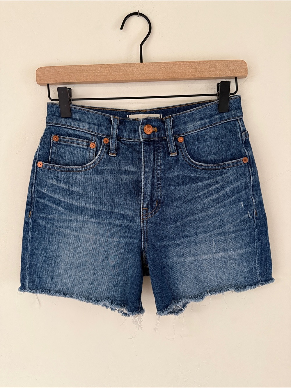 Madewell medium-blue denim shorts with frayed hem. Size 24.